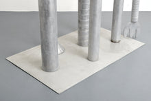 Load image into Gallery viewer, Detail of Base:Carol K. Brown (b. 1945 - ) Untitled Sculpture: Six Vertical Elements., 1986 Aluminum Sculpture 53h x 48w x 30d inches Carol K. Brown is a visual artist based in Miami and New York. She began her career as a sculptor, but her work has evolved through numerous phases: anthropomorphic abstractions, figurative paintings, and social commentary. This aluminum statue is composed of six separate pieces on an aluminum base. Available at Manolis Projects Gallery.