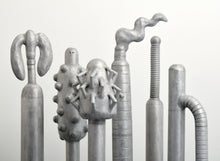 Load image into Gallery viewer, Detail of Top:Carol K. Brown (b. 1945 - ) Untitled Sculpture: Six Vertical Elements., 1986 Aluminum Sculpture 53h x 48w x 30d inches Carol K. Brown is a visual artist based in Miami and New York. She began her career as a sculptor, but her work has evolved through numerous phases: anthropomorphic abstractions, figurative paintings, and social commentary. This aluminum statue is composed of six separate pieces on an aluminum base. Available at Manolis Projects Gallery.