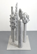 Load image into Gallery viewer, Side View:Carol K. Brown (b. 1945 - ) Untitled Sculpture: Six Vertical Elements., 1986 Aluminum Sculpture 53h x 48w x 30d inches Carol K. Brown is a visual artist based in Miami and New York. She began her career as a sculptor, but her work has evolved through numerous phases: anthropomorphic abstractions, figurative paintings, and social commentary. This aluminum statue is composed of six separate pieces on an aluminum base. Available at Manolis Projects Gallery.