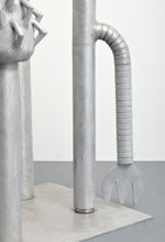 Load image into Gallery viewer, Detail:Carol K. Brown (b. 1945 - ) Untitled Sculpture: Six Vertical Elements., 1986 Aluminum Sculpture 53h x 48w x 30d inches Carol K. Brown is a visual artist based in Miami and New York. She began her career as a sculptor, but her work has evolved through numerous phases: anthropomorphic abstractions, figurative paintings, and social commentary. This aluminum statue is composed of six separate pieces on an aluminum base. Available at Manolis Projects Gallery.