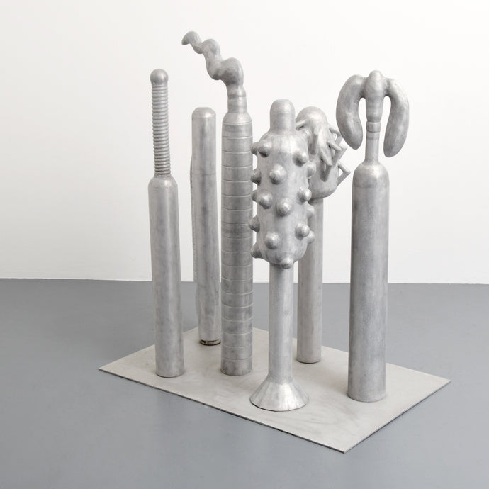 Carol K. Brown (b. 1945 - ) Untitled Sculpture: Six Vertical Elements., 1986 Aluminum Sculpture 53h x 48w x 30d inches  Carol K. Brown is a visual artist based in Miami and New York. She began her career as a sculptor, but her work has evolved through numerous phases: anthropomorphic abstractions, figurative paintings, and social commentary. This aluminum statue is composed of six separate pieces on an aluminum base. Available at Manolis Projects Gallery.