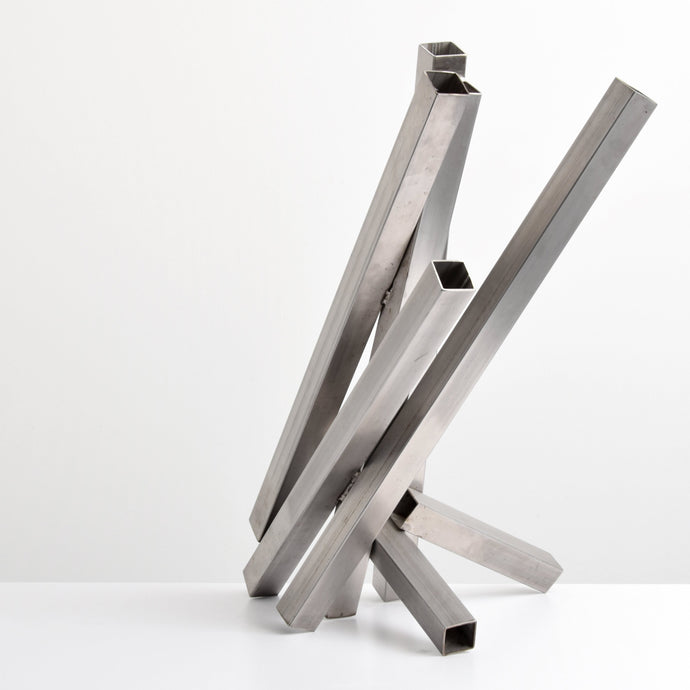 Tony Rosenthal (1914-2009), N.A., Crocus, 1979, Sculpture of Welded Stainless Steel, 33.5 x 24 x  20 inches,  This sculpture is composed of seven square-shaped hollow beams, welded together in diagonal orientations. Rosenthal's work is collected by major museums, including Museum of Modern Art (MoMA). Tony Rosenthal Sculpture